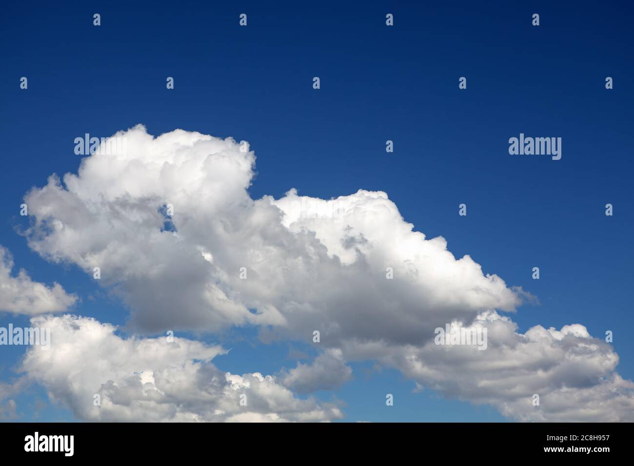 Summer typical clouds with deep blue sky Stock Photo