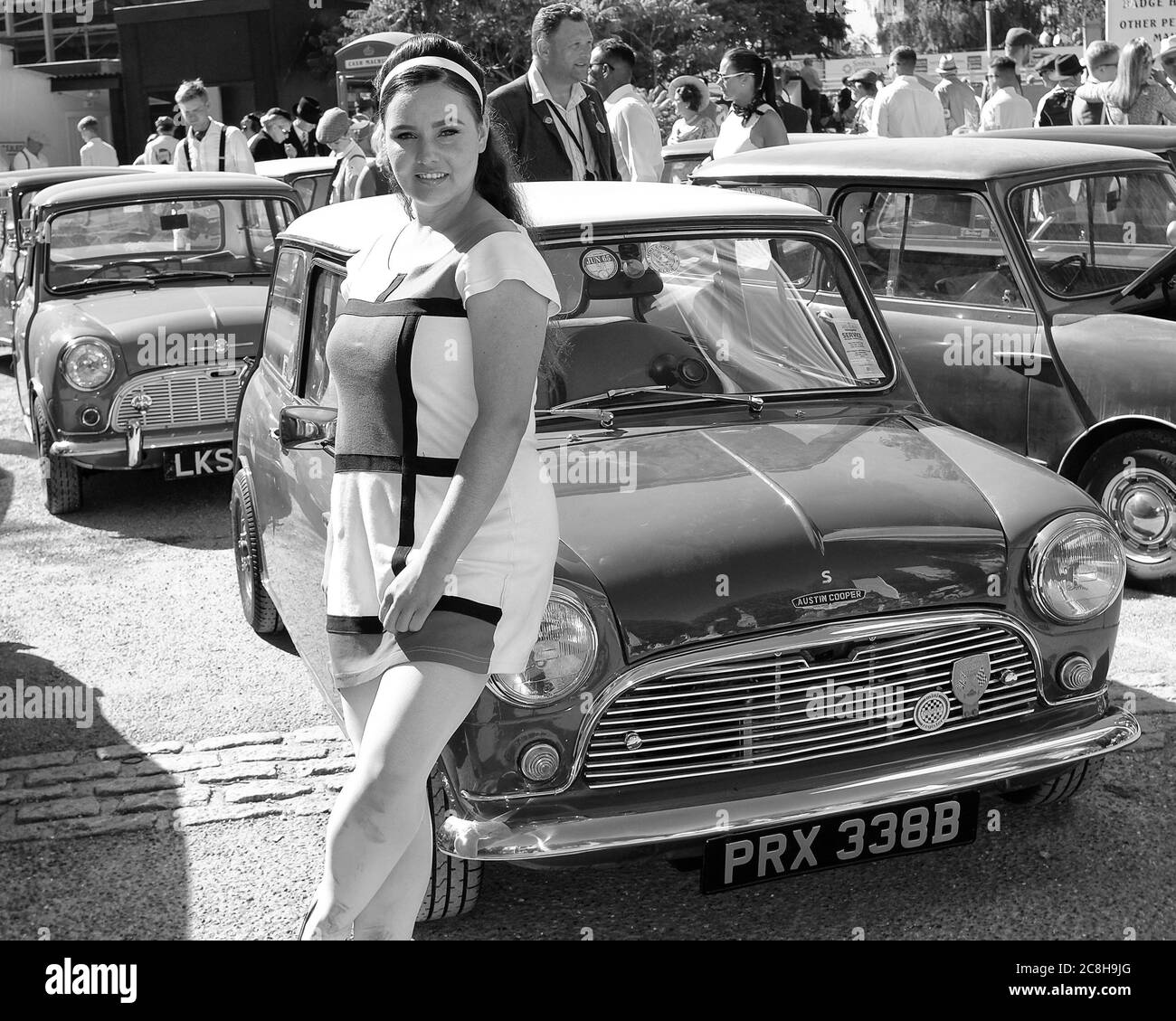September 2019 - An actor model posing beside a Mini Cooper S at The Goodwood Revival Stock Photo