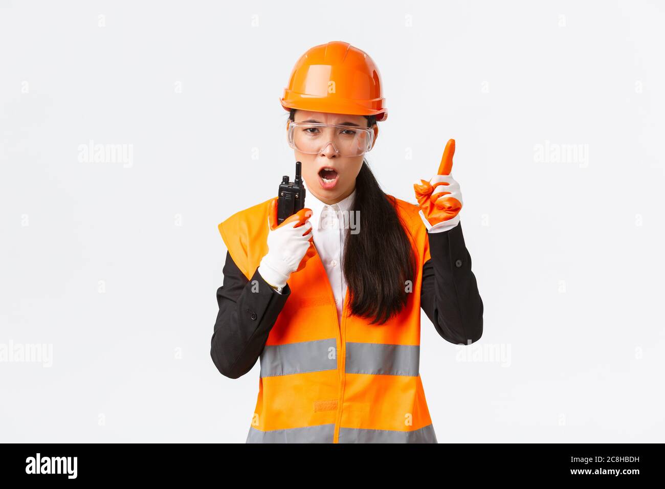 Serious-looking asian female industrial engineer, technician in safety ...