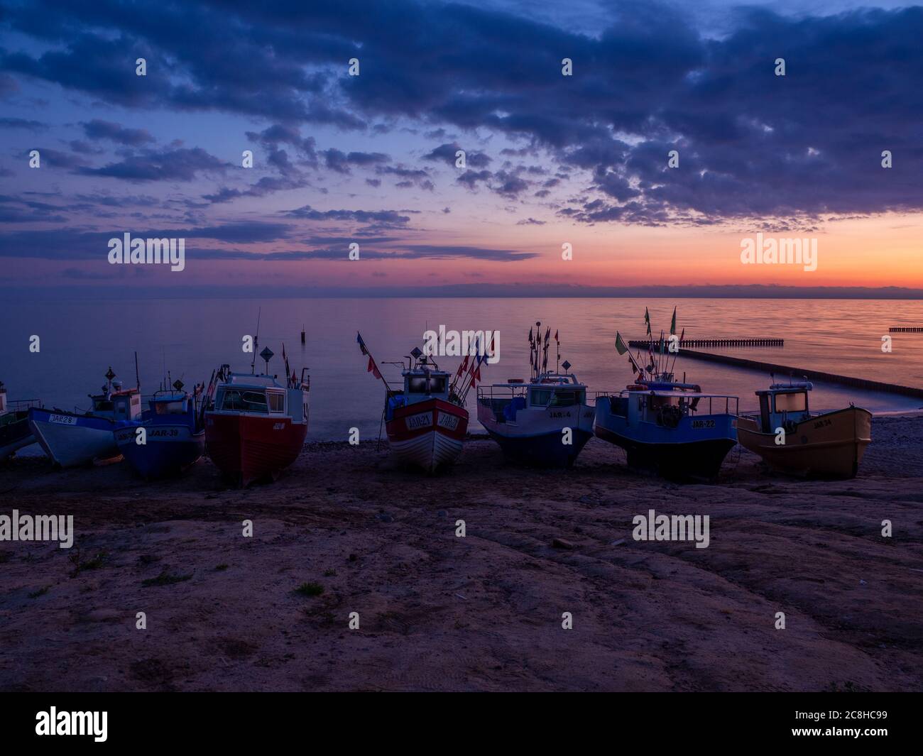fishing boats at the beach of the Baltic Sea shortly befor sunrise Stock Photo