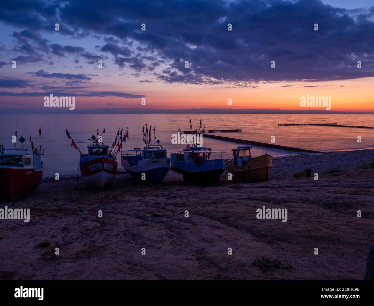 fishing boats at the beach of the Baltic Sea shortly befor sunrise Stock Photo