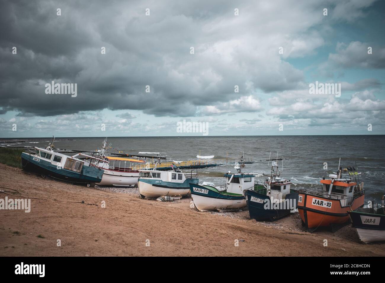 At the beach of Jaroslawiec in Poland fishing boats lie on the beach of the Baltic Sea Stock Photo