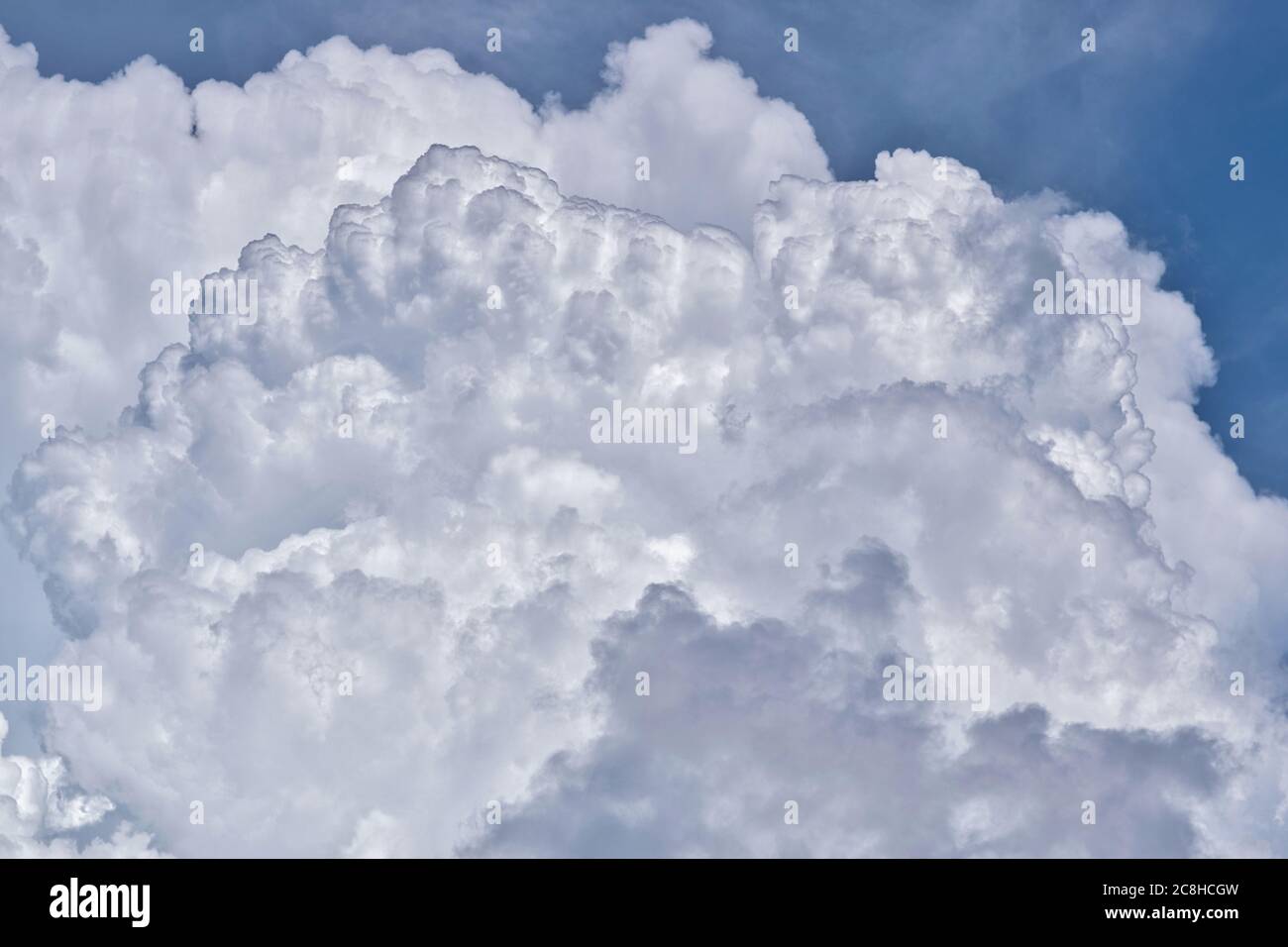 Towering Cumulus clouds forming in the sky before the onset of a thunderstorm in a tropical climate. Stock Photo