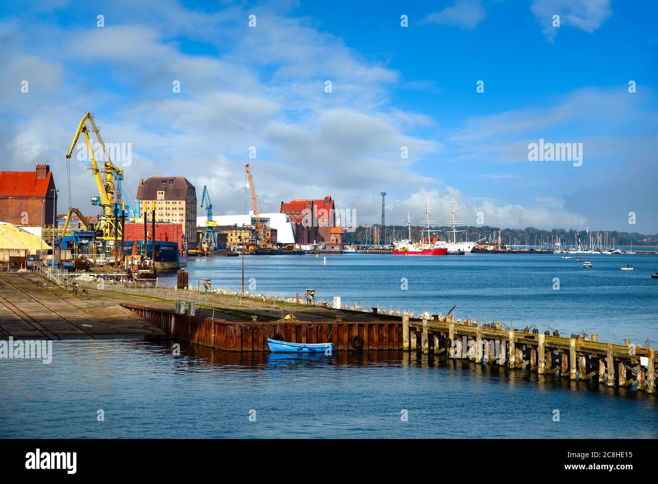 Panoramic view of the commercial harbor of Stralsund with cranes, ships and industrial buildings Stock Photo