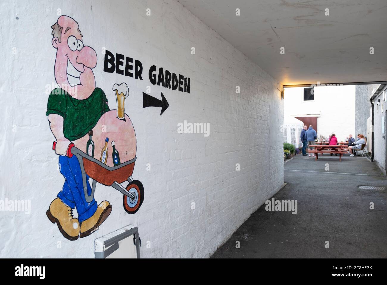 Cartoon sign pointing the way to a pub beer garden, Dalbeattie, Dumfries and Galloway, Scotland. Stock Photo