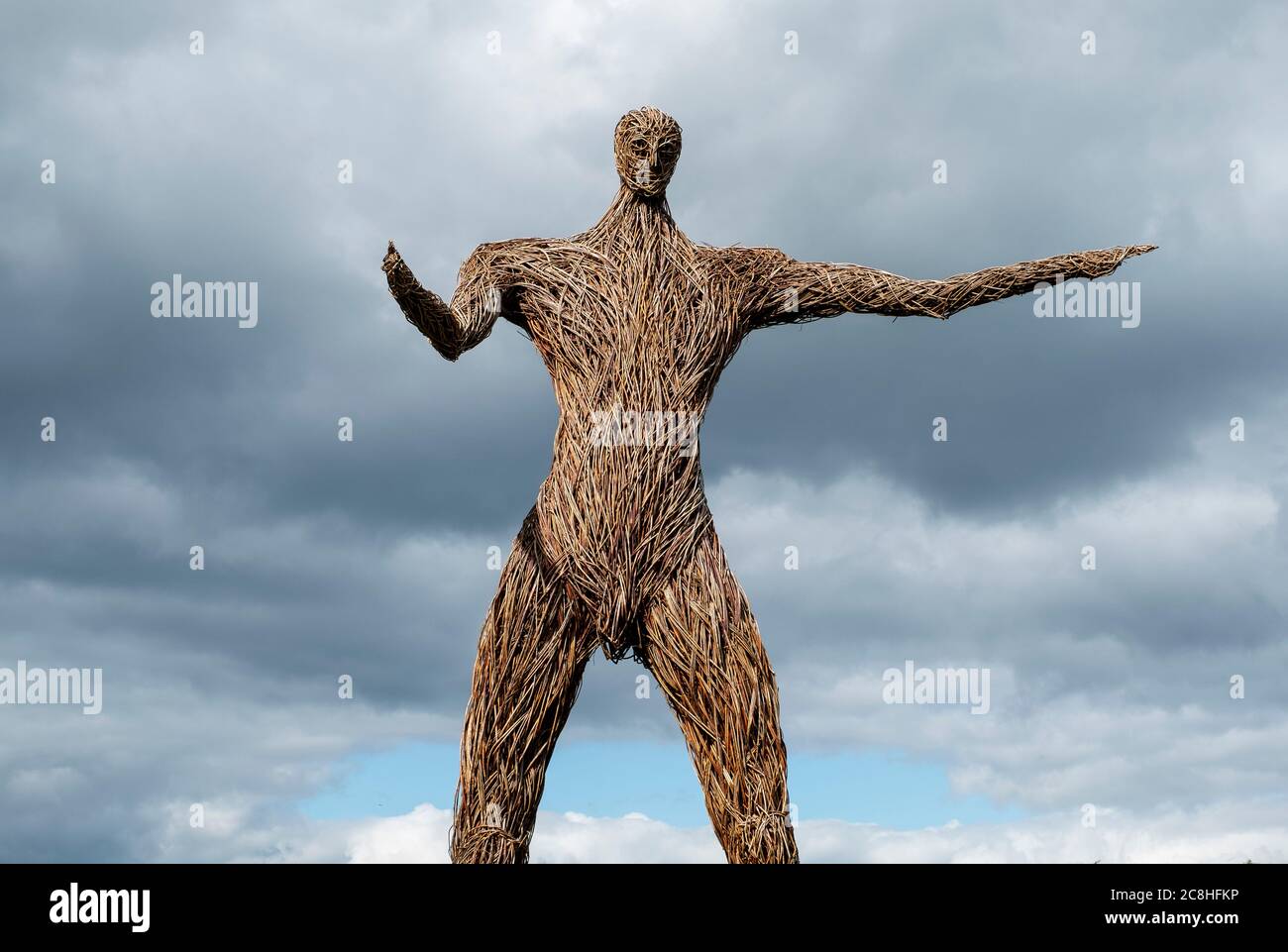 A wicker man sculpture stands with outstretched arms in a rural field near Dundrennan, Dumfries and Galloway, Scotland Stock Photo