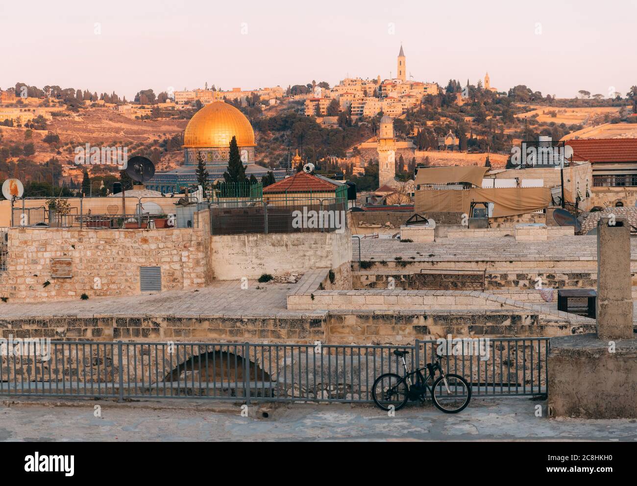 View of Old Jerusalem from the Mount. View of old city from the roof, with lattice and bicycle on foreground. Sunset time over Jerusalem. Jerusalem da Stock Photo