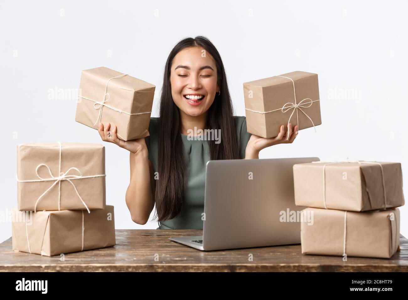 Small business owners, startup and e-commerce concept. Smiling successful shop manager, businesswoman with internet store packing client order for Stock Photo