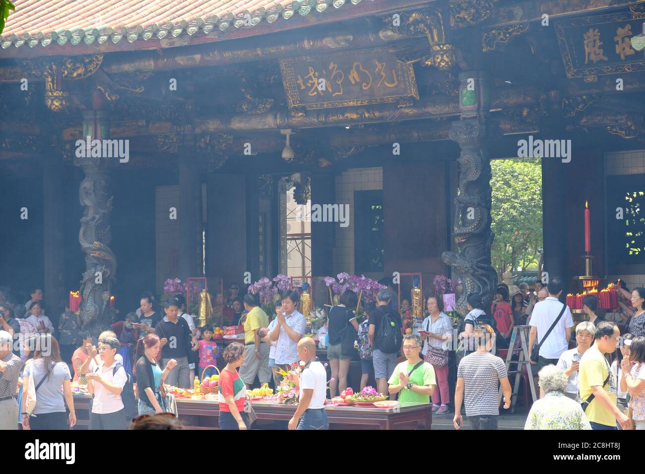Taipei Taiwan - Lungshan Temple busy scene of buddhist people praying Stock Photo