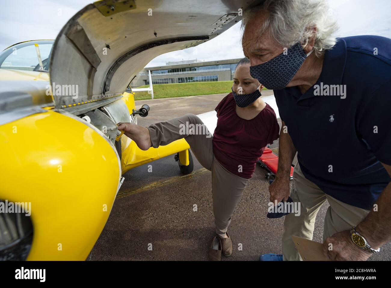 Frederick, United States. 24th July, 2020. Tucson, Arizona, pilot Jessica Cox, who was born without arms and uses her feet and toes in place of hands, checks the oil of her single-engine Ercoupe aircraft with fellow pilot and former Sen. Tom Harkin, D-Iowa, in Frederick, Maryland, Friday, July 24, 2020. Photo by David Tulis/UPI. Credit: UPI/Alamy Live News Stock Photo