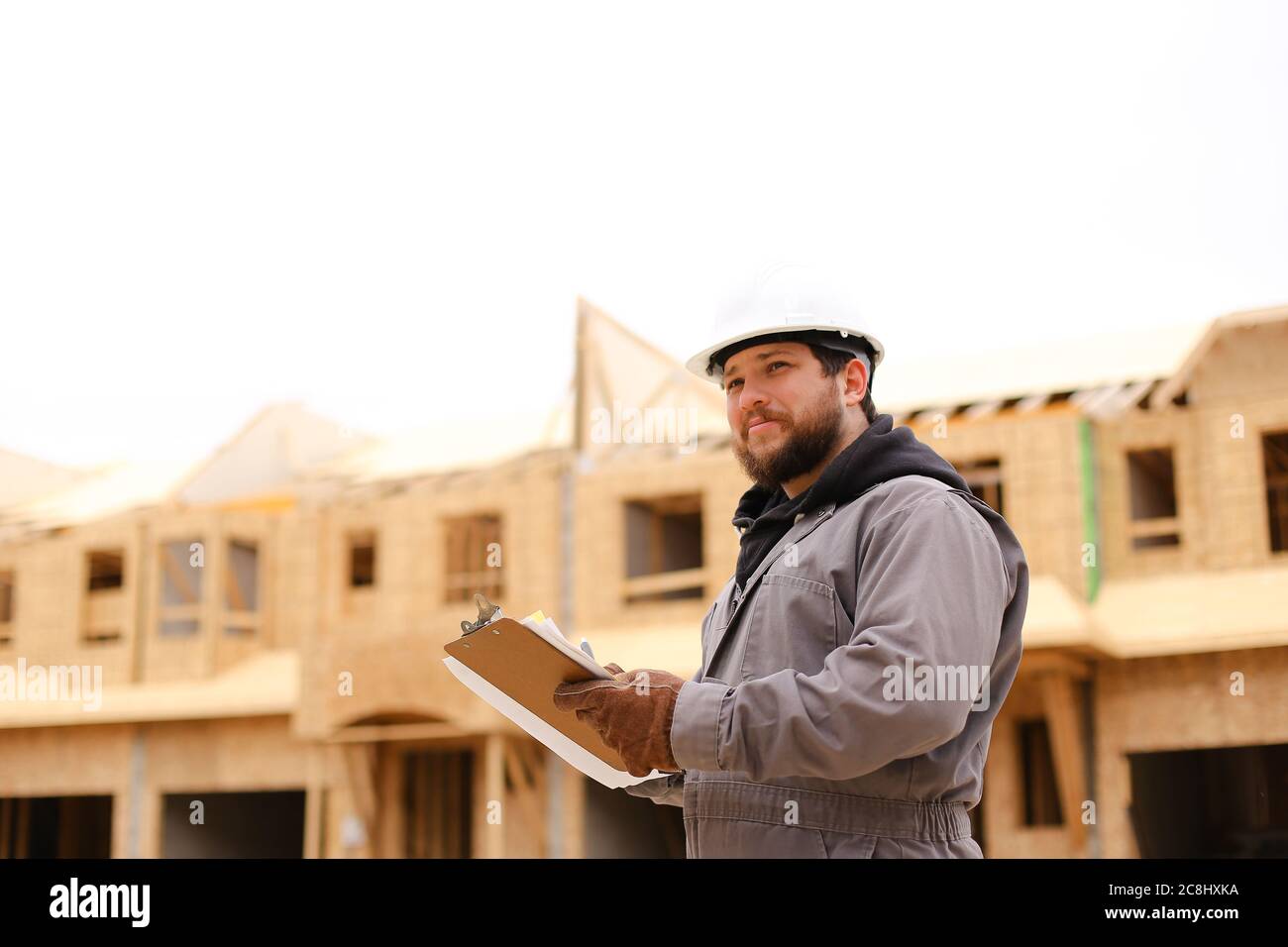 Male architect drawing plan in notebook at construction site. Stock Photo