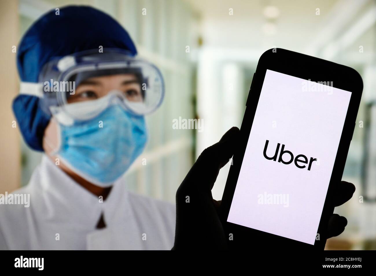 In this photo illustration an Uber app logo seen displayed on a ...