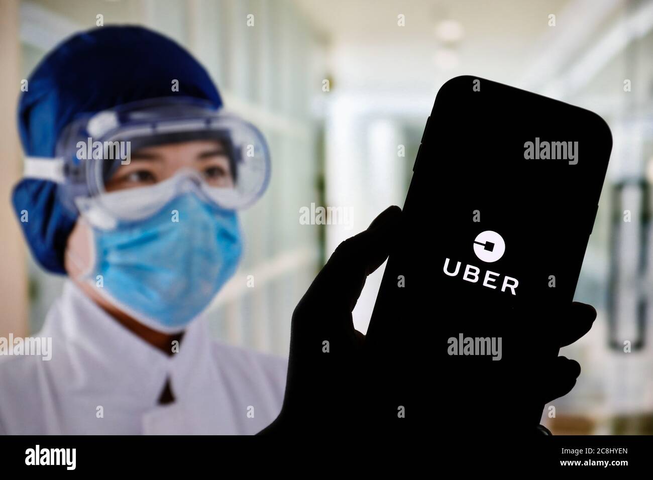In this photo illustration an Uber app logo seen displayed on a ...