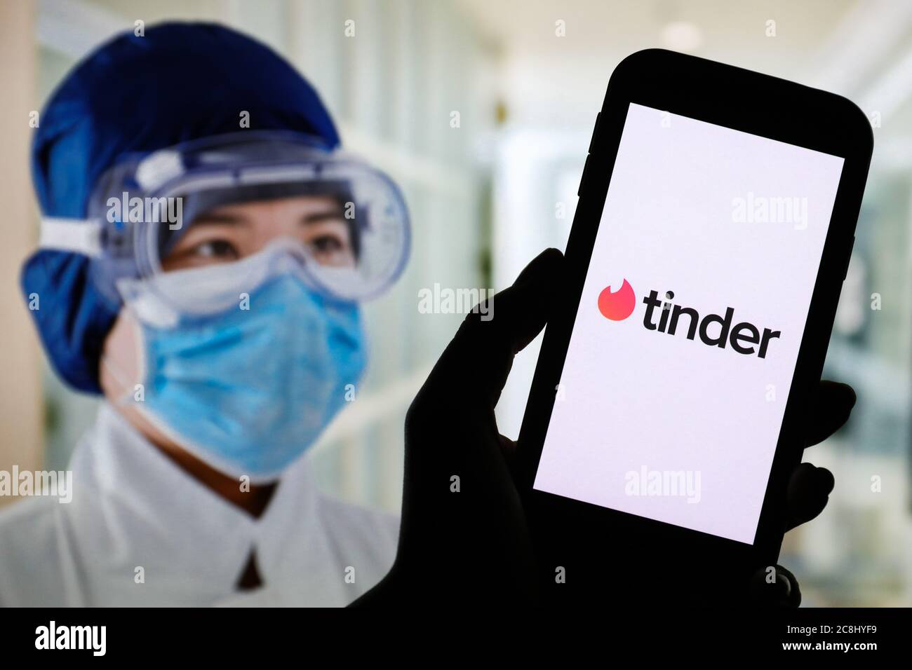 In this photo illustration a Tinder dating app logo seen displayed on a smartphone. Stock Photo