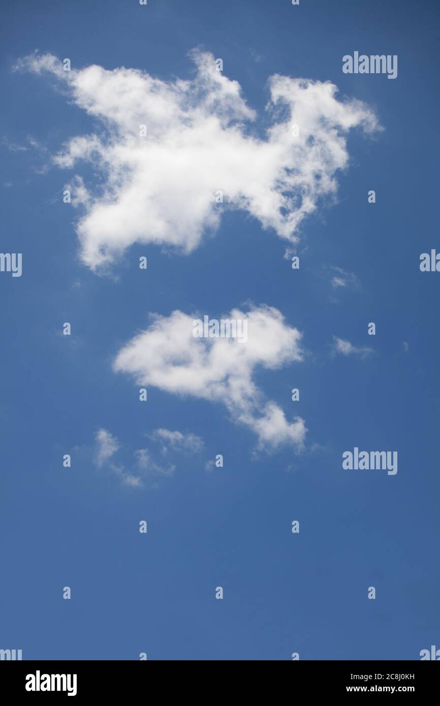 Puffy clouds against a blue sky Stock Photo