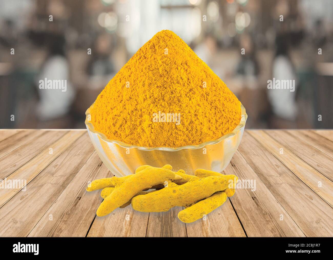 Indian spice Turmeric Powder (Haldi) in a glass bowl with Turmeric