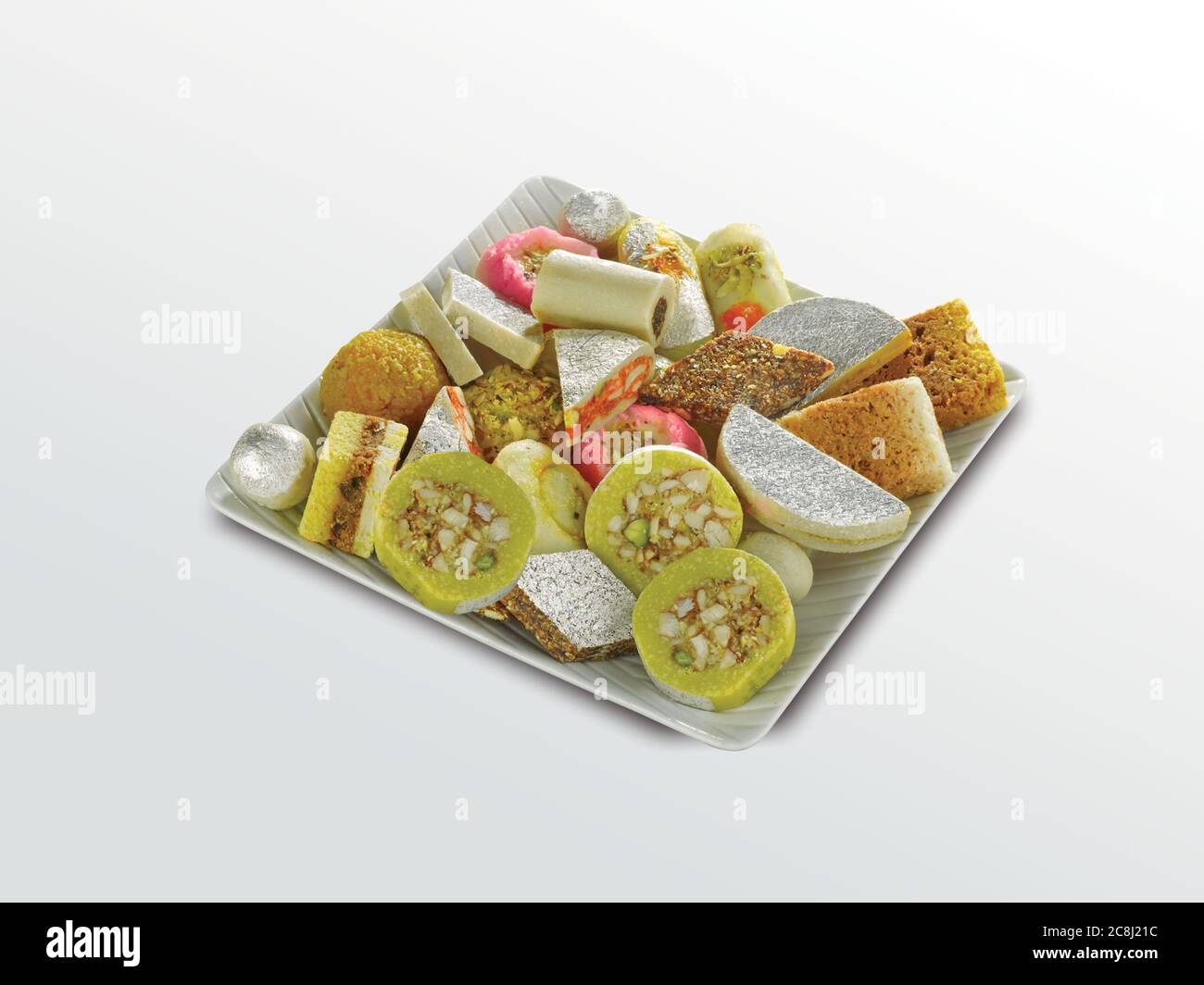 Stock photo of Indian sweets served in silver or wooden plate. variety of Peda, burfi, laddu in decorative plate, selective focus Stock Photo