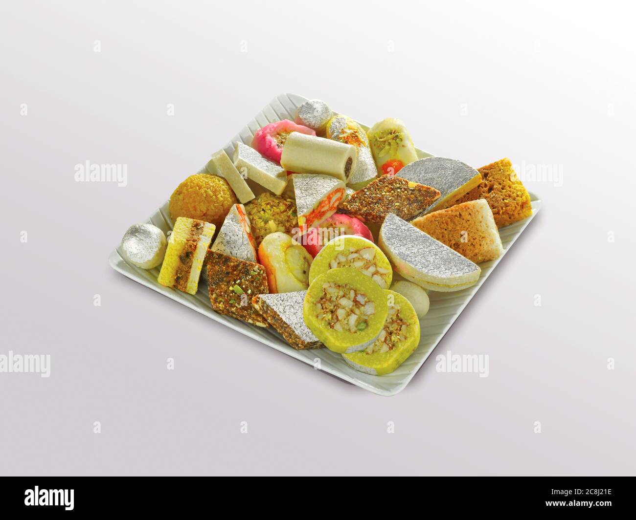 Stock photo of Indian sweets served in silver or wooden plate. variety of Peda, burfi, laddu in decorative plate, selective focus Stock Photo
