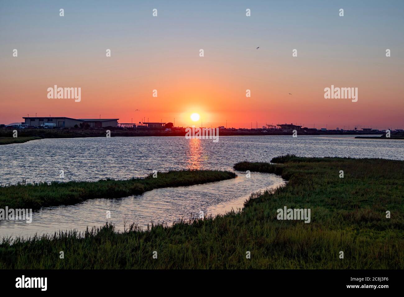 Sunset over wetlands and marsh taken at Bolsa Chica Wetland and Ecological Reserve in Huntington Beach, California, USA Stock Photo