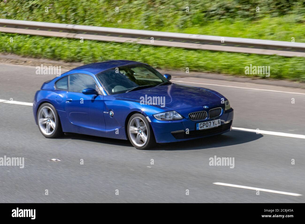 2007 blue BMW Z4 SI Sport; Vehicular traffic moving vehicles, cars driving vehicle on UK roads, motors, motoring on the M6 motorway highway network. Stock Photo