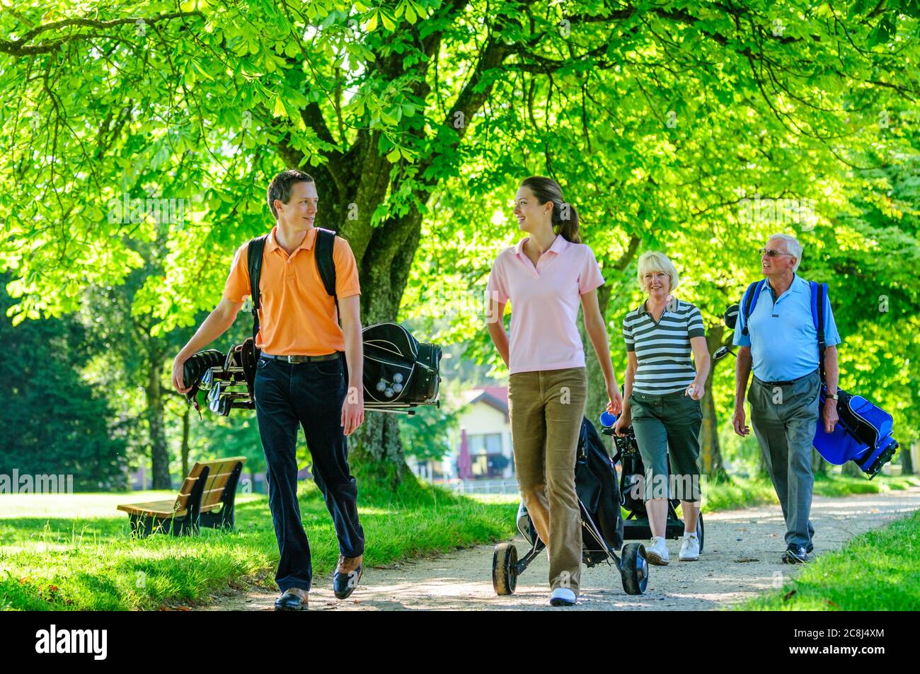 A group of golfers walking to the next tee Stock Photo