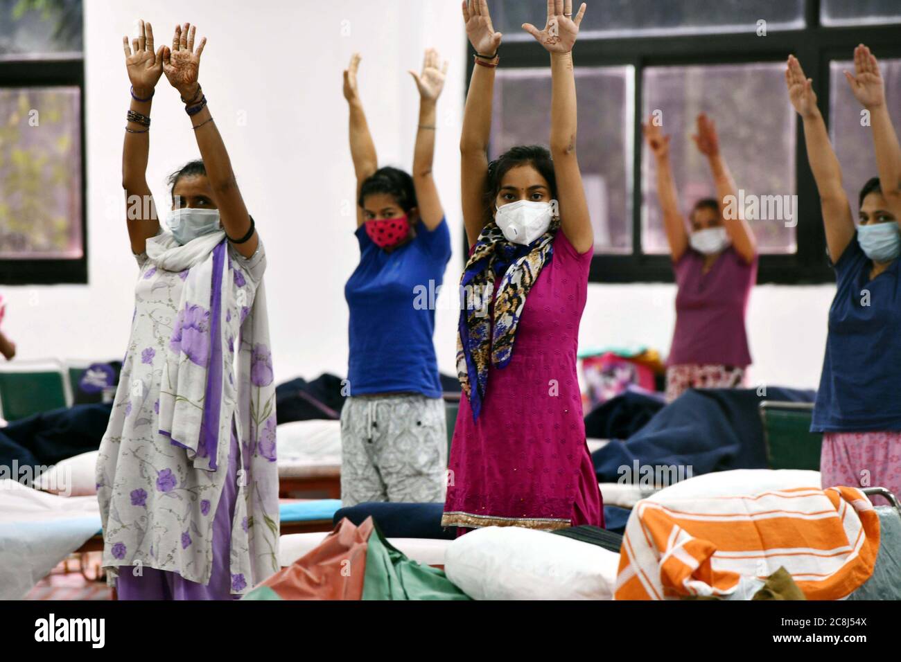 (200725) -- NEW DELHI, July 25, 2020 (Xinhua) -- Patients do yoga at a COVID-19 care center in New Delhi, India, July 24, 2020. India's health ministry said on Saturday morning that 757 new deaths due to COVID-19, besides fresh 48,916 positive cases, were reported during the past 24 hours across the country, taking the number of deaths to 31,358 and total cases to 1,336,861. (Photo by Partha Sarkar/Xinhua) Stock Photo