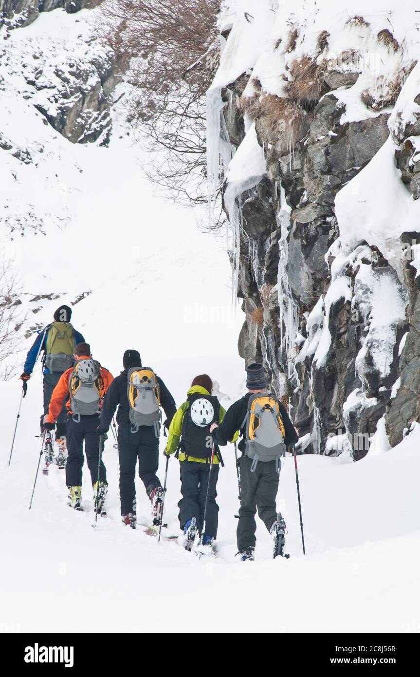 A group of ski mountaineerers exploring Haute Maurienne region on a cold and snowy day Stock Photo