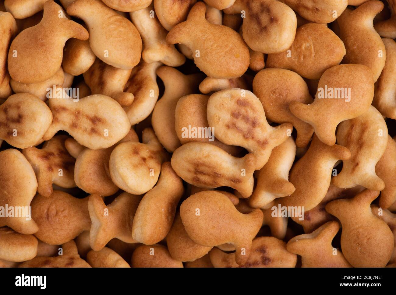 Pile of fish-shaped cookies, salt crackers background Stock Photo