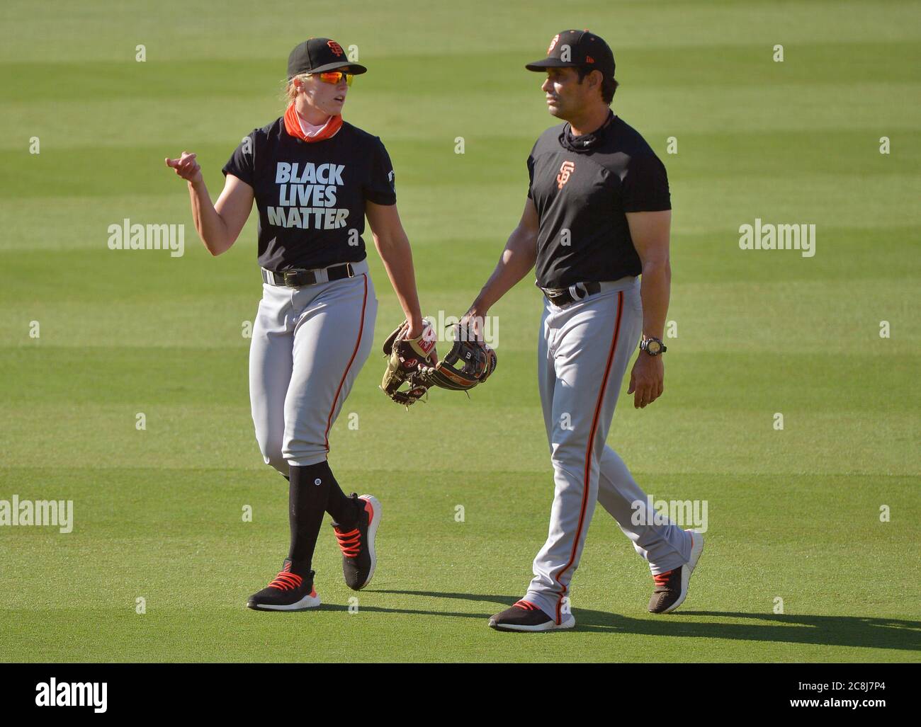 Los Angeles, United States. 24th July, 2020. San Francisco Giants first  base coach Alyssa Nakken (L) participates in a pre-game workout with the  Los Angeles Dodgers at Dodger Stadium in Los Angeles