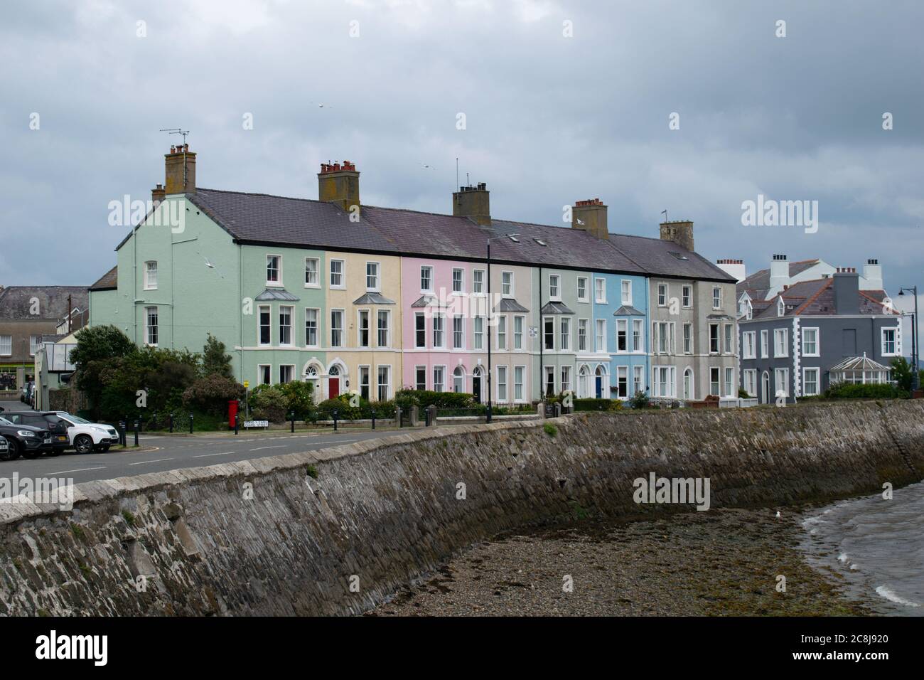 West End Terraces Beaumaris,  Anglesey,  Wales, UK. Brightly coloured row of terraced houses along the seafront Stock Photo