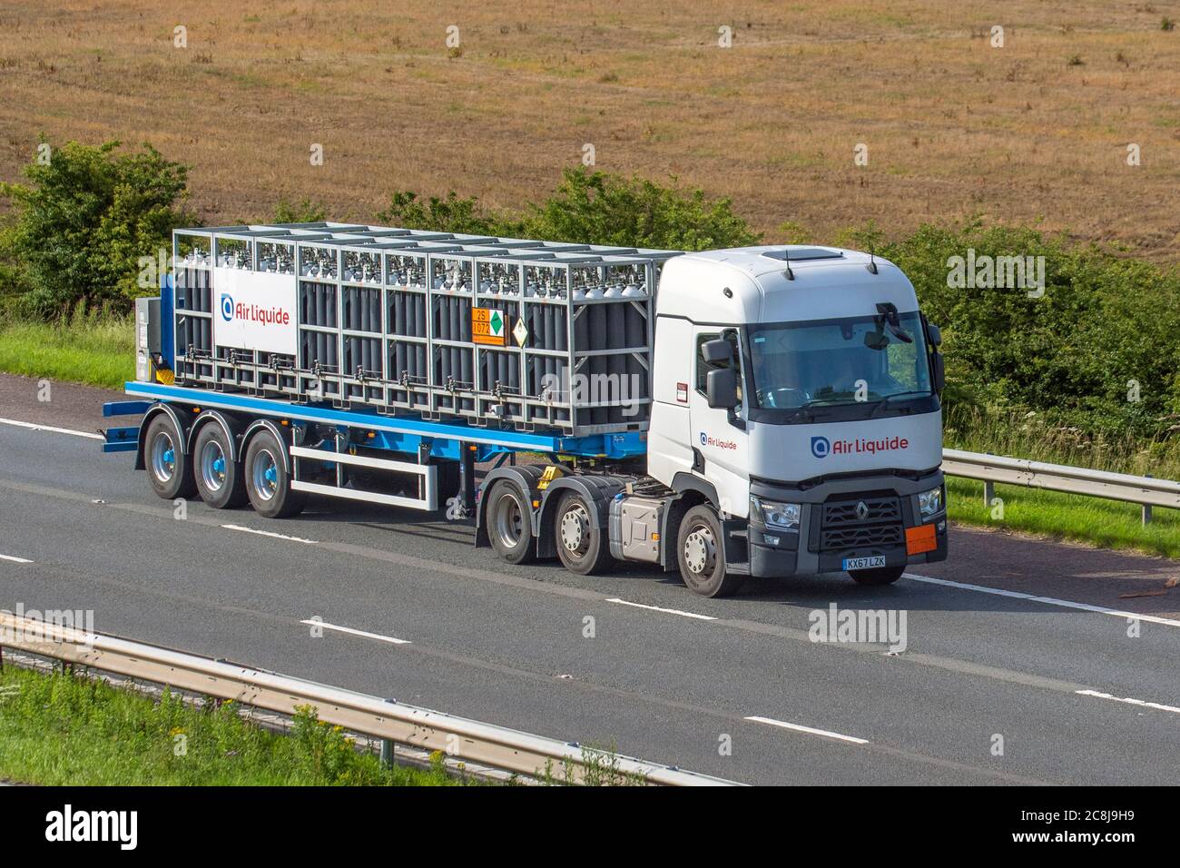 Air Liquide bottled gases, Haulage delivery trucks, lorry, transportation, truck, cargo carrier, Renault vehicle, European commercial transport, industry, M61 at Manchester, UK Stock Photo