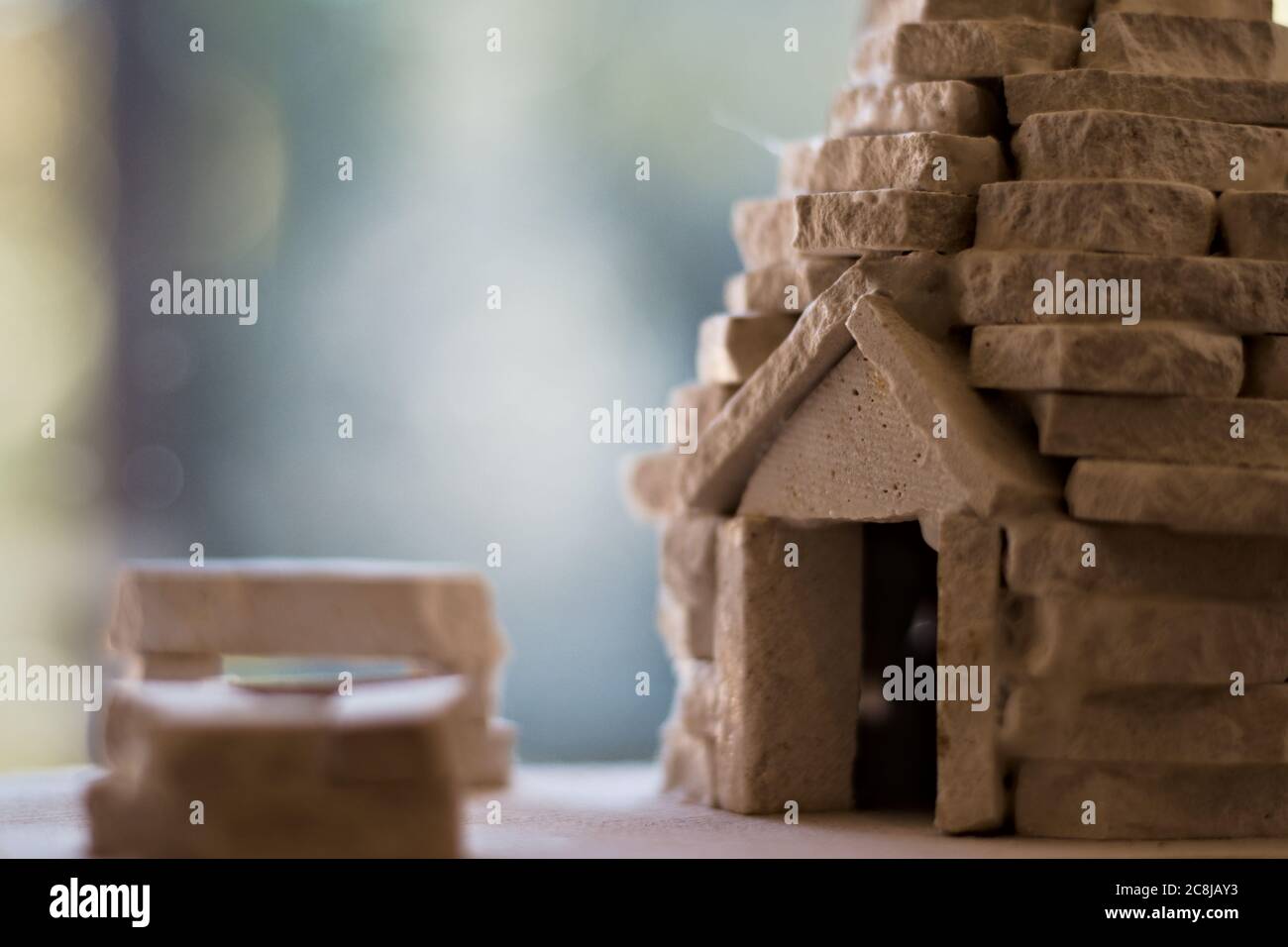 Miniature house model made from stones Stock Photo
