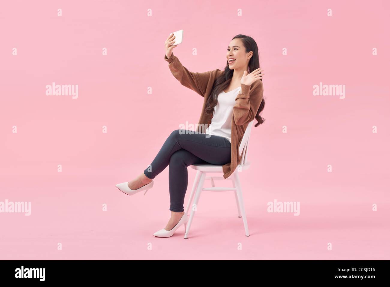 Portrait of young woman looking at mobile phone Stock Photo