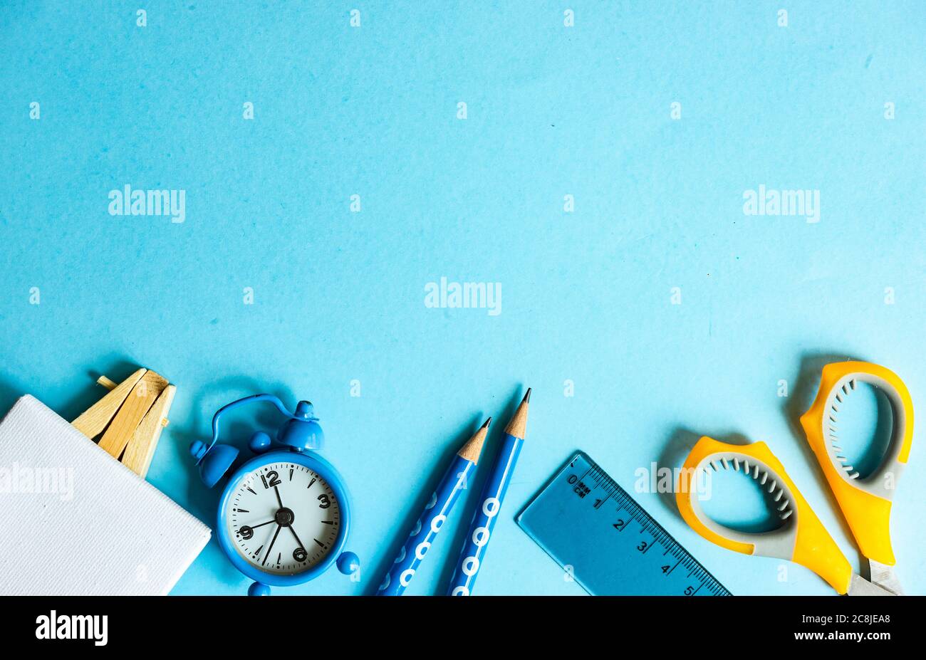 Back to School flatlay on blue background with copy space Stock Photo
