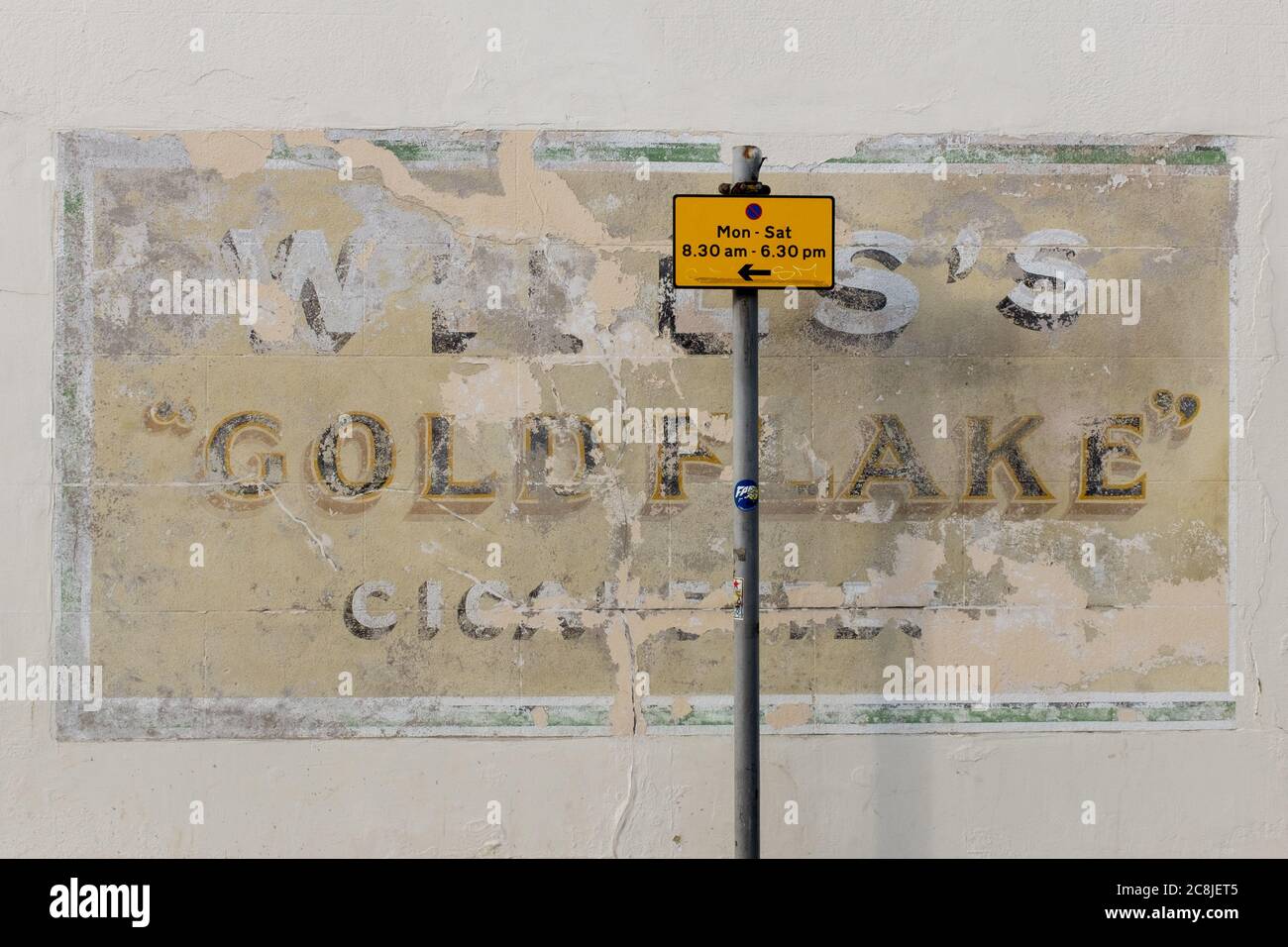 A detail of old advertising for a cigarette brand from decades ago called Will's whose product was 'Goldflake', on 19th July 2020, in Whitstable, Kent, England. W.D. & H.O. Wills was a British tobacco importer and manufacturer formed in Bristol, England. W.D. & H.O. Wills was founded in 1786 and was the first UK company to mass-produce cigarettes. It was one of the founding companies of Imperial Tobacco along with John Player & Sons. Stock Photo