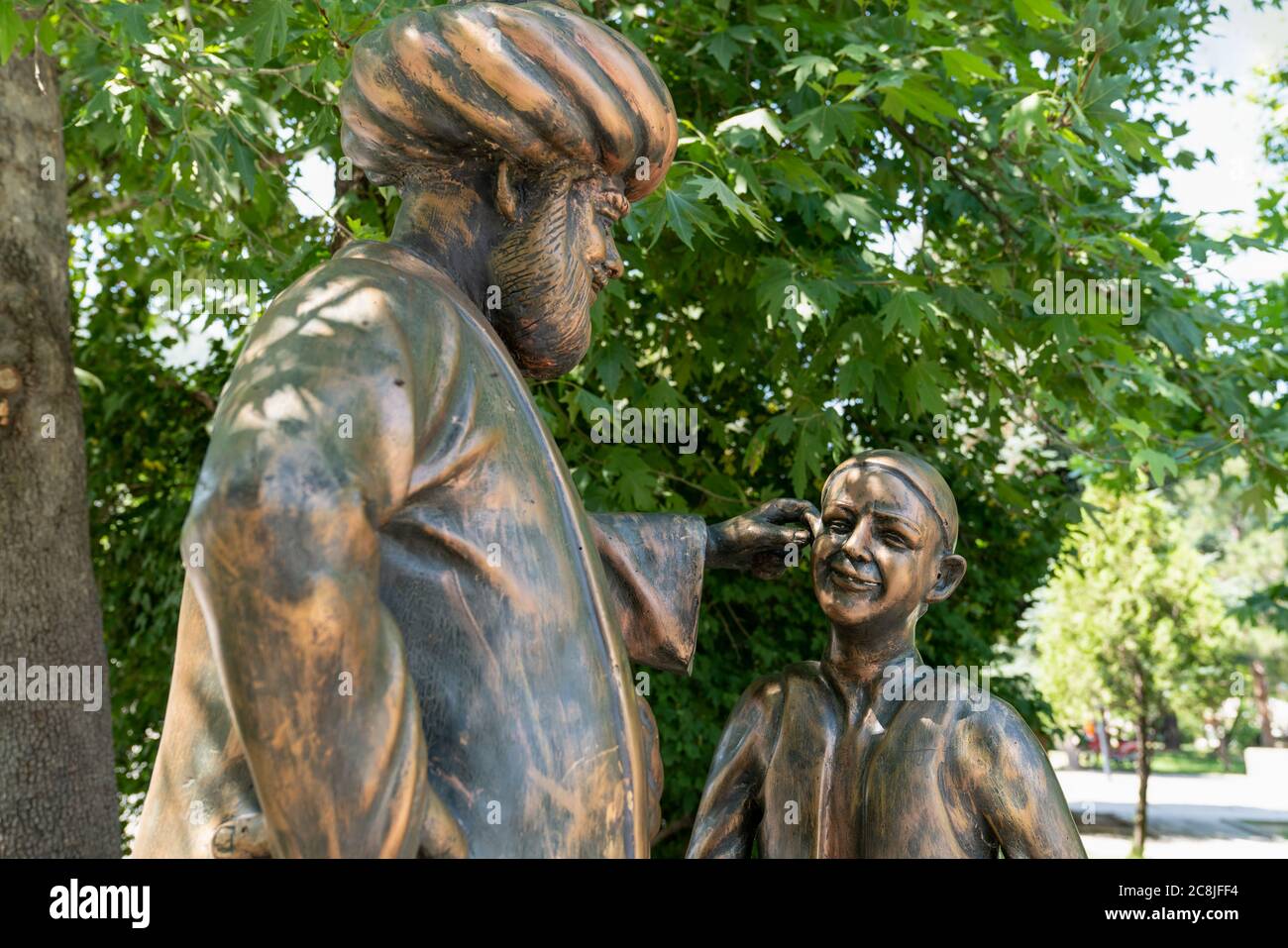 Aksehir, Konya/Turkey- July 18 2020:  Nasrettin Hoca pulls a child's ear in his sculpture which it is symbolize one of his jokes. Stock Photo