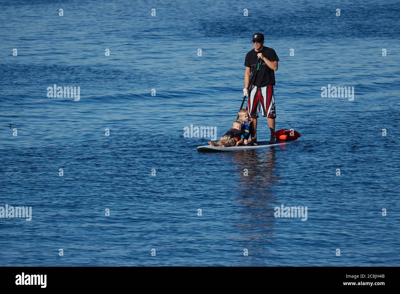 Man With 2 Young Boys On A Paddle Board At Redondo Beach, California, USA. Stock Photo