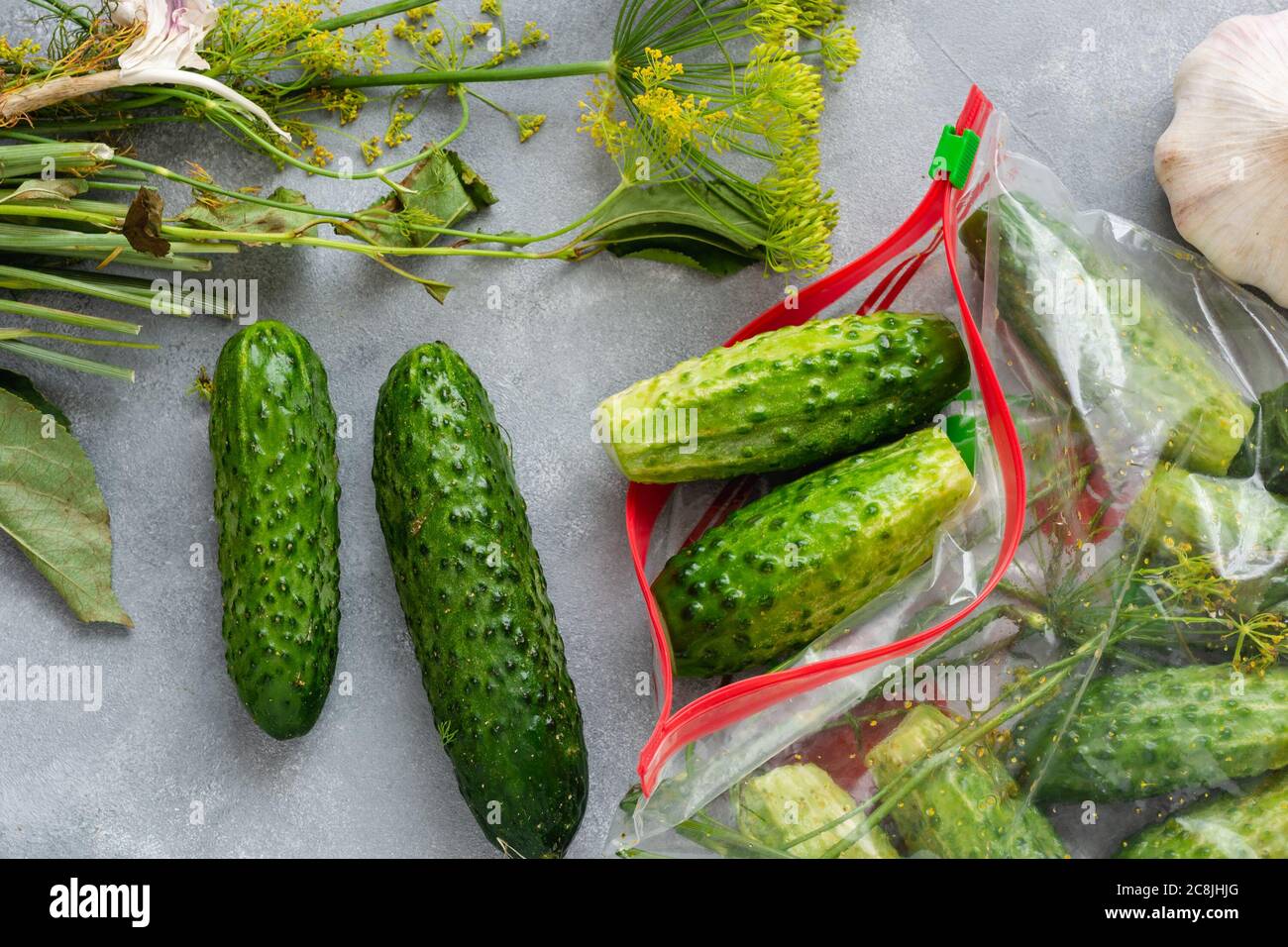 Low-salt cucumbers in a bag. Crunching salted cucumbers without brine. Dry salting - a method of cooking pickles. Stock Photo