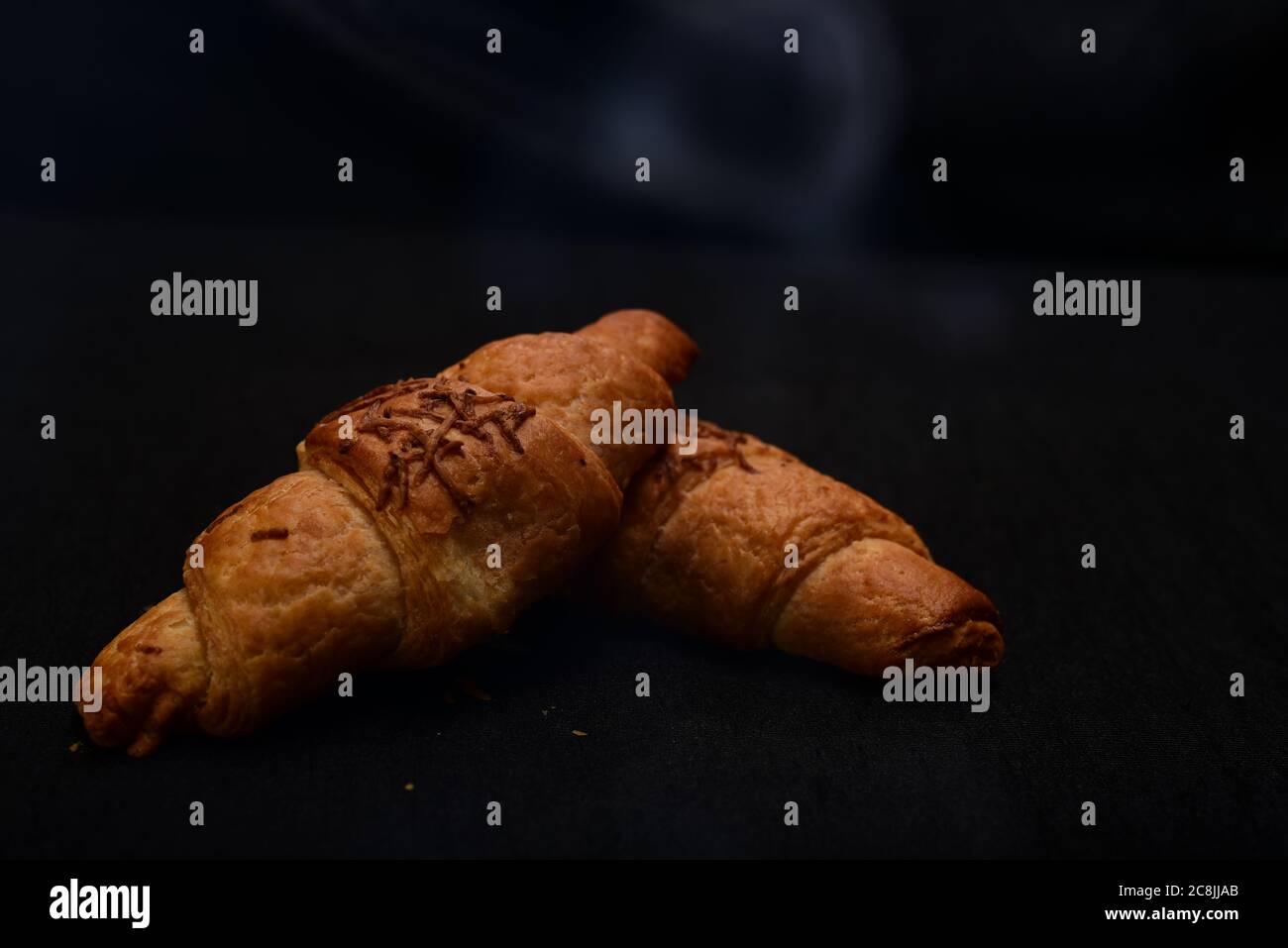 hot bread with smoke on black background.Food background and wallpapers Stock Photo