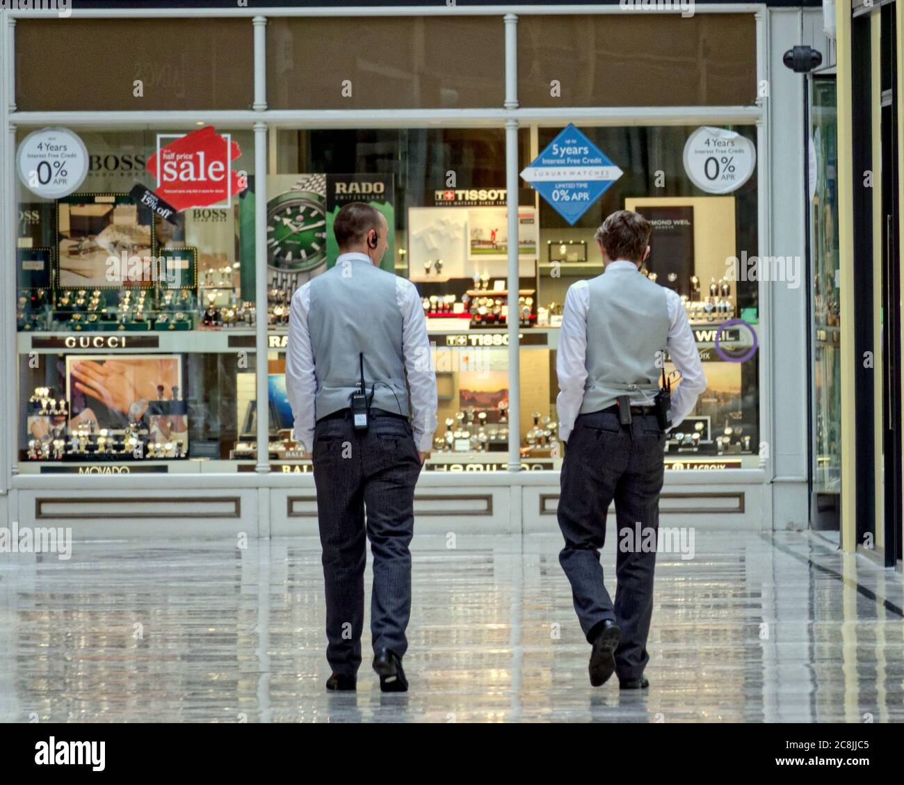 Glasgow, Scotland, UK 25tht July, 2020:The city continues to be in different times as social distancing sees individuals alone and Saturday shopping mornings see little activity for  pre Coronavirus busy day. Security personel patrol an empty argyle arcade on a not so busy saturday.. Credit: Gerard Ferry/Alamy Live News Stock Photo