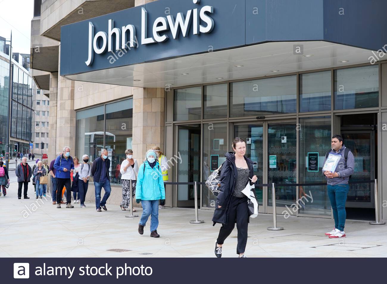 Edinburgh, Scotland, UK. 25th Jul 2020. Saturday shoppers wearing facemasks in a socially distanced queue for controlled entry to John Lewis department store.  Credit: Craig Brown/Alamy Live News Stock Photo