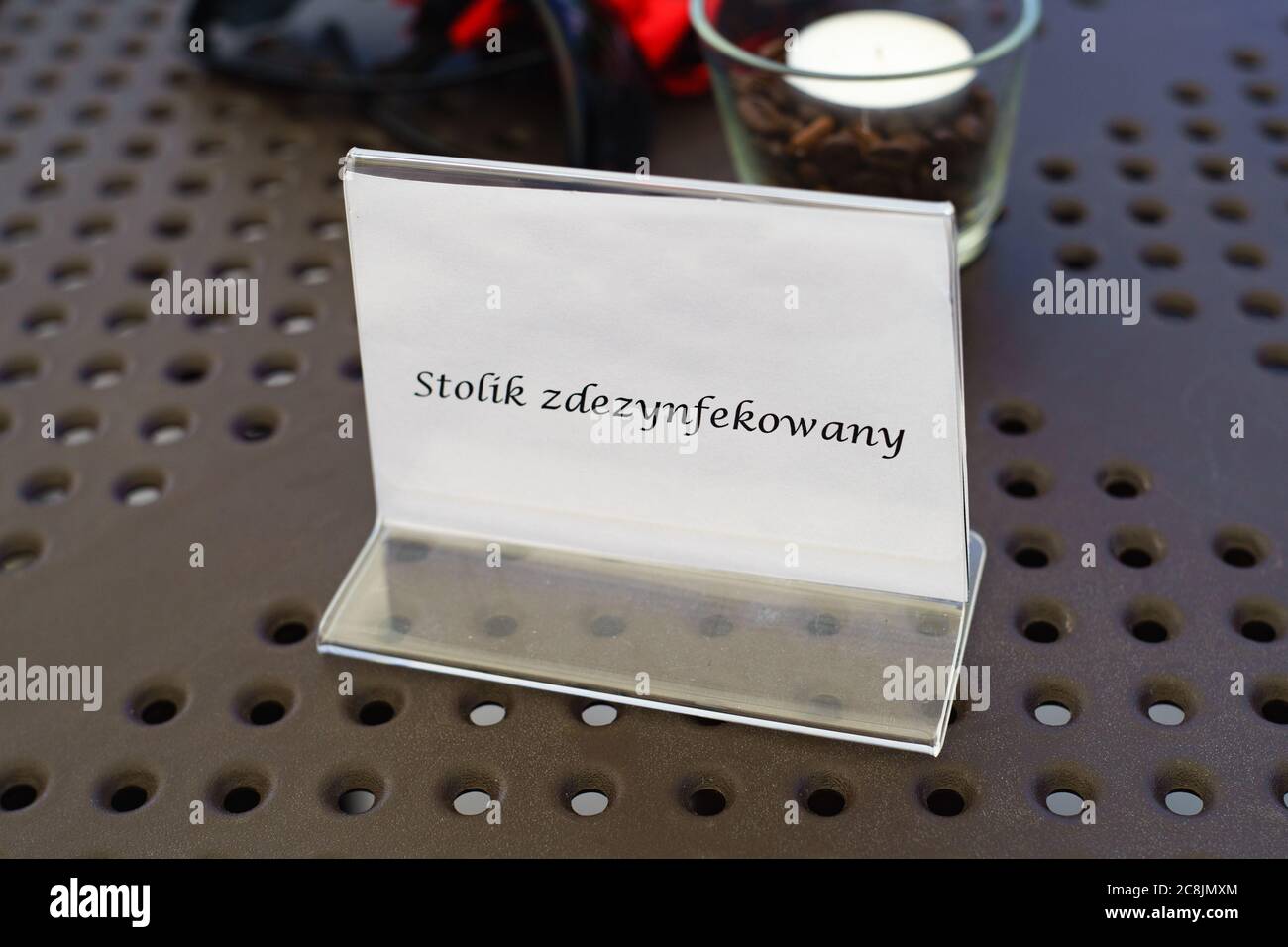 PSZCZYNA, POLAND - Jul 22, 2020: A plate on the table in a Polish restaurant with the words 'disinfected table'. Stock Photo