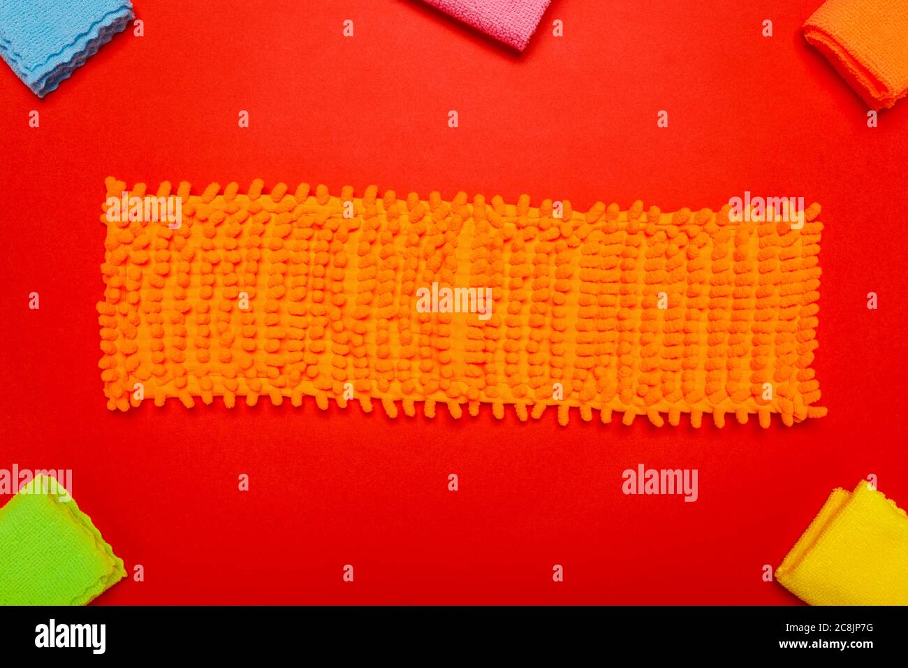 rags for cleaning. rags of different colors and a floor rag on a red ...