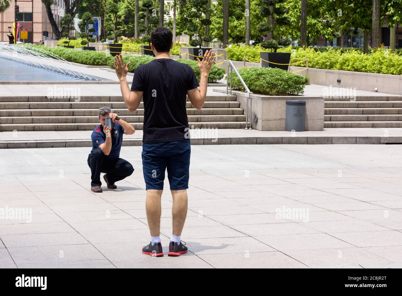 KUALA LUMPUR, MALAYSIA - FEBRUARY 20, 2017 - Tourist man taking picture at KLCC park Stock Photo