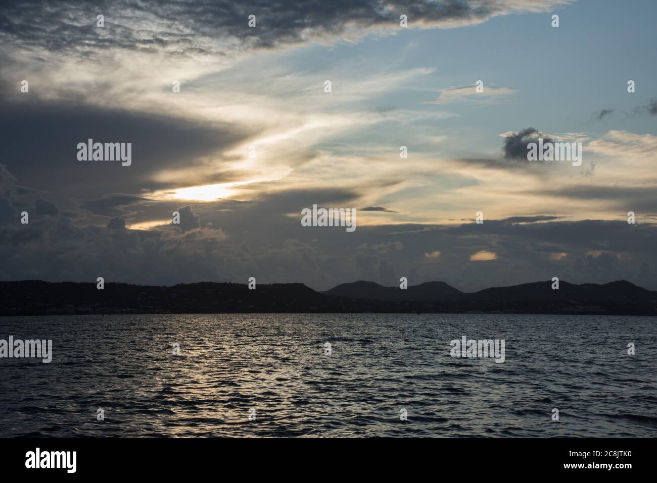 Rolling island shoreline with rippling Caribbean Sea waters during sunset on St. Croix in the USVI Stock Photo