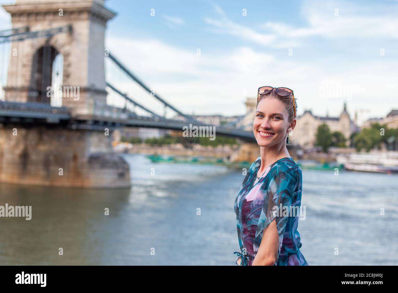 Young natural redhead woman smiling at Danube, Budapest, Hungary Stock Photo