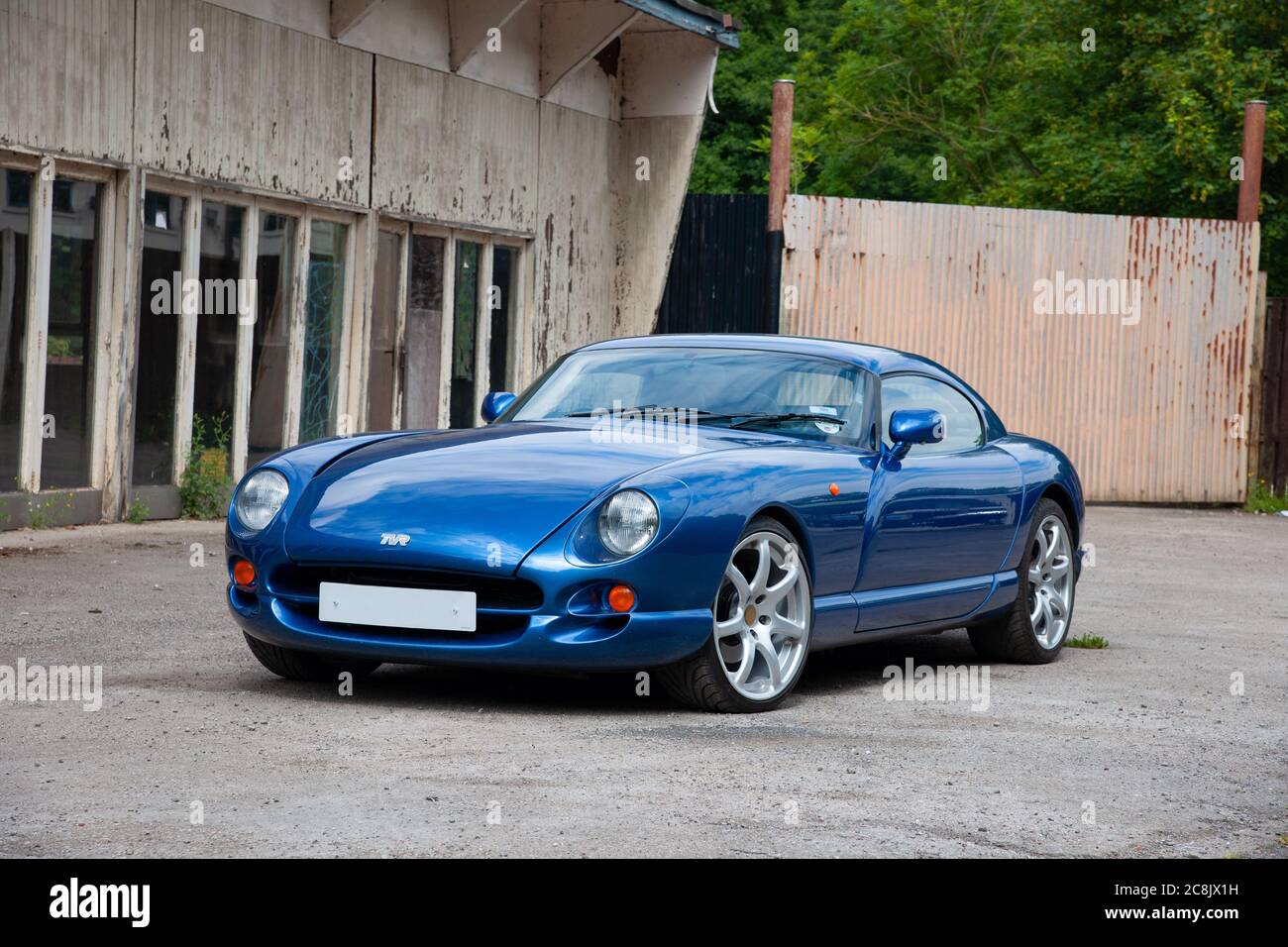 British TVR Cerbera muscle car parked in front of a disused garage showroom Stock Photo