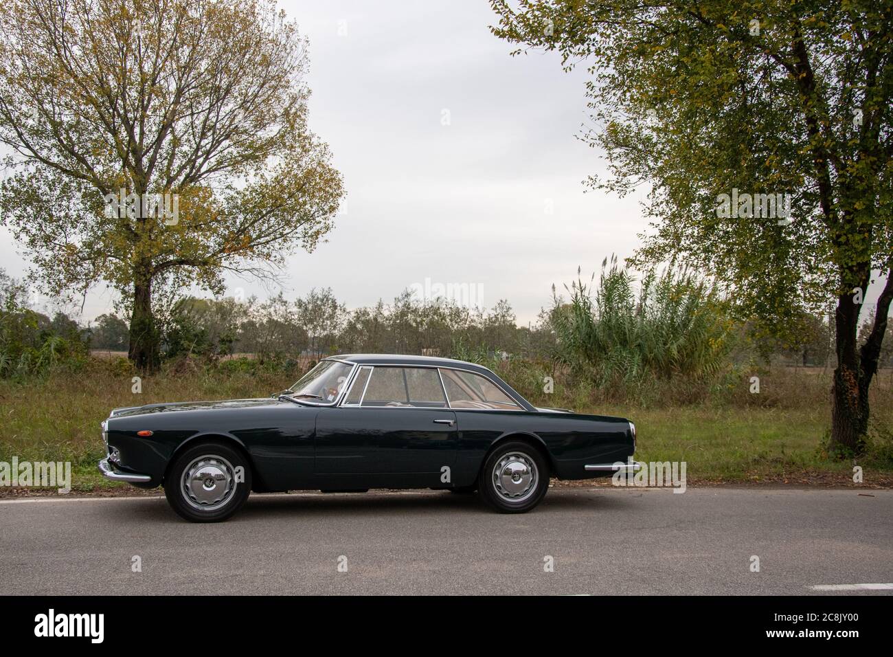 Touring-designed 1960 Alfa Romeo Praho coupe parked on a rural lane near Milan, Italy. Stock Photo