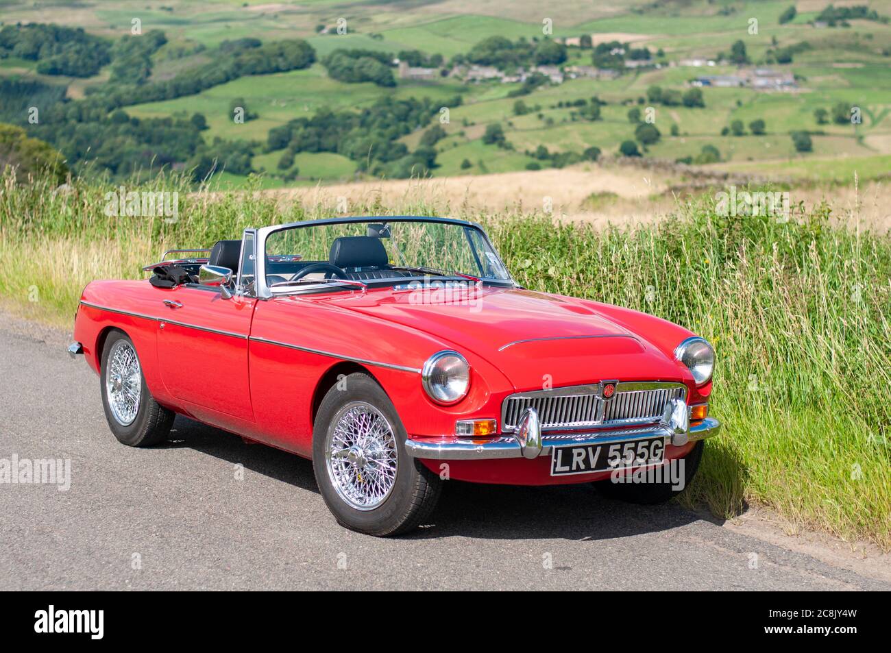 Chrome bumper MGB GT British classic car standing on a country lane in