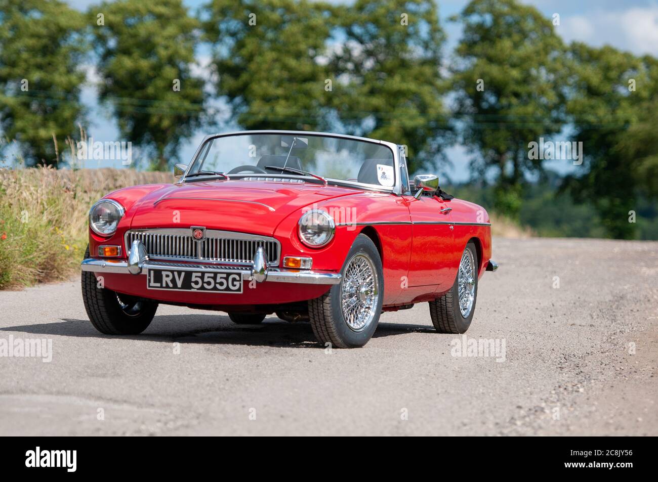 Chrome bumper MGB GT British classic car standing on a country lane in